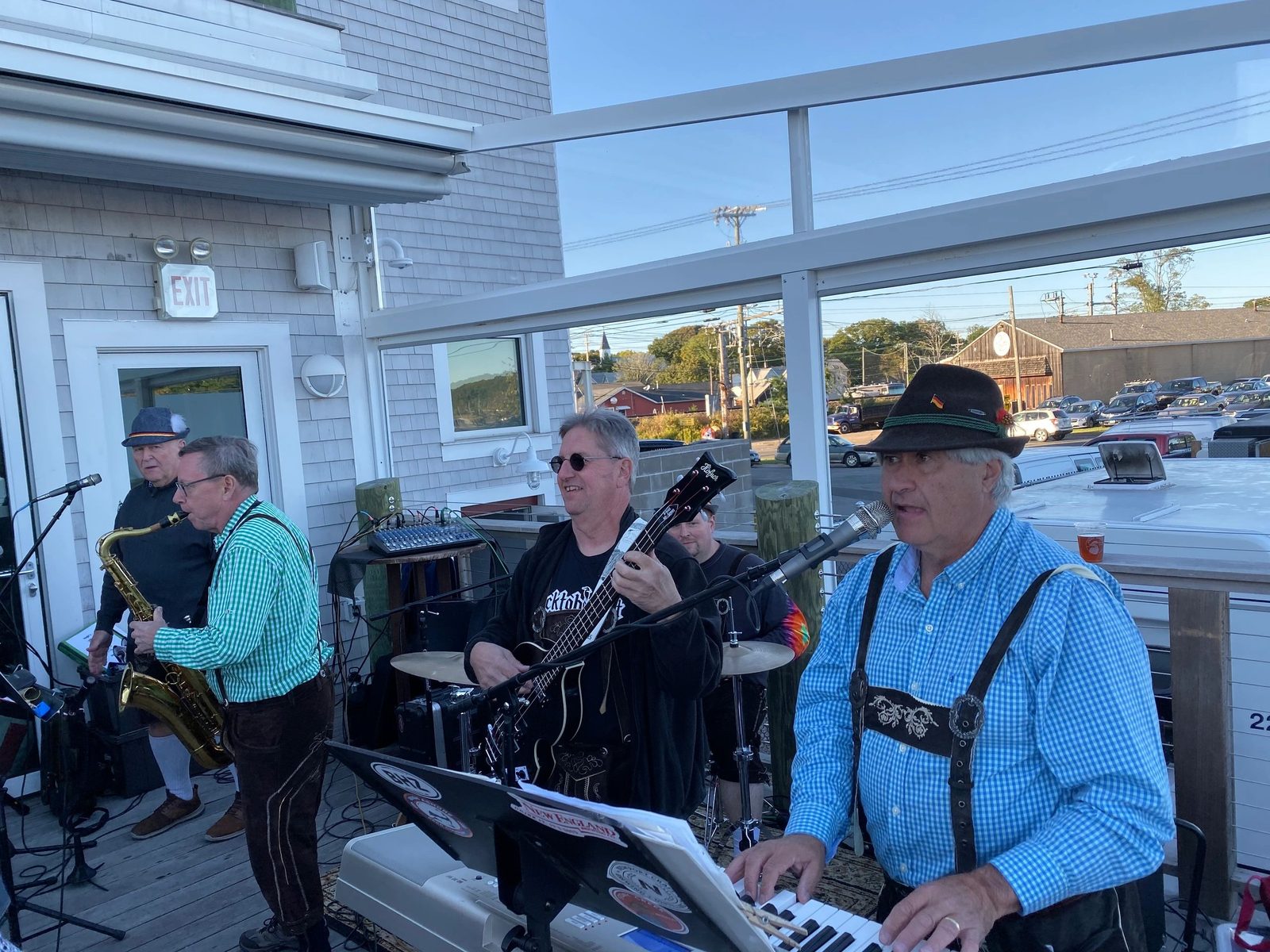 The Beer Hall Boys on an outdoor deck in lederhosen and alpine hats