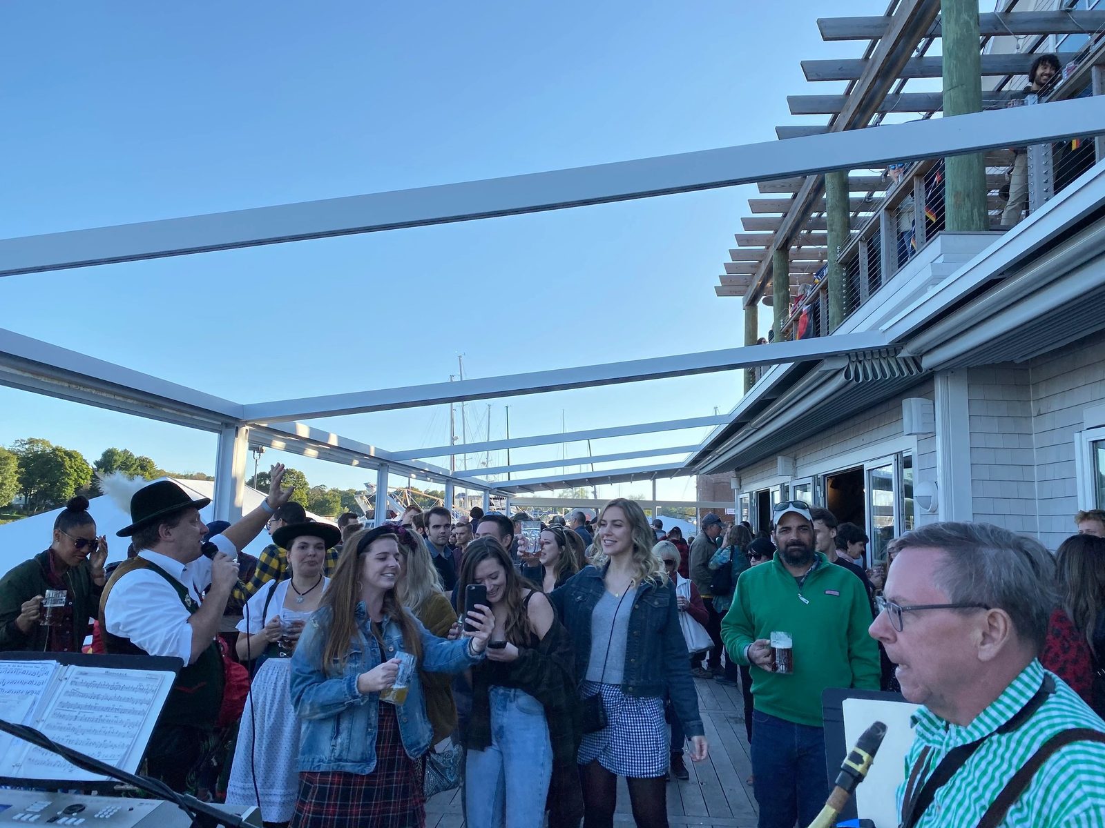 Docktoberfest crowd and band on a sunny New England deck