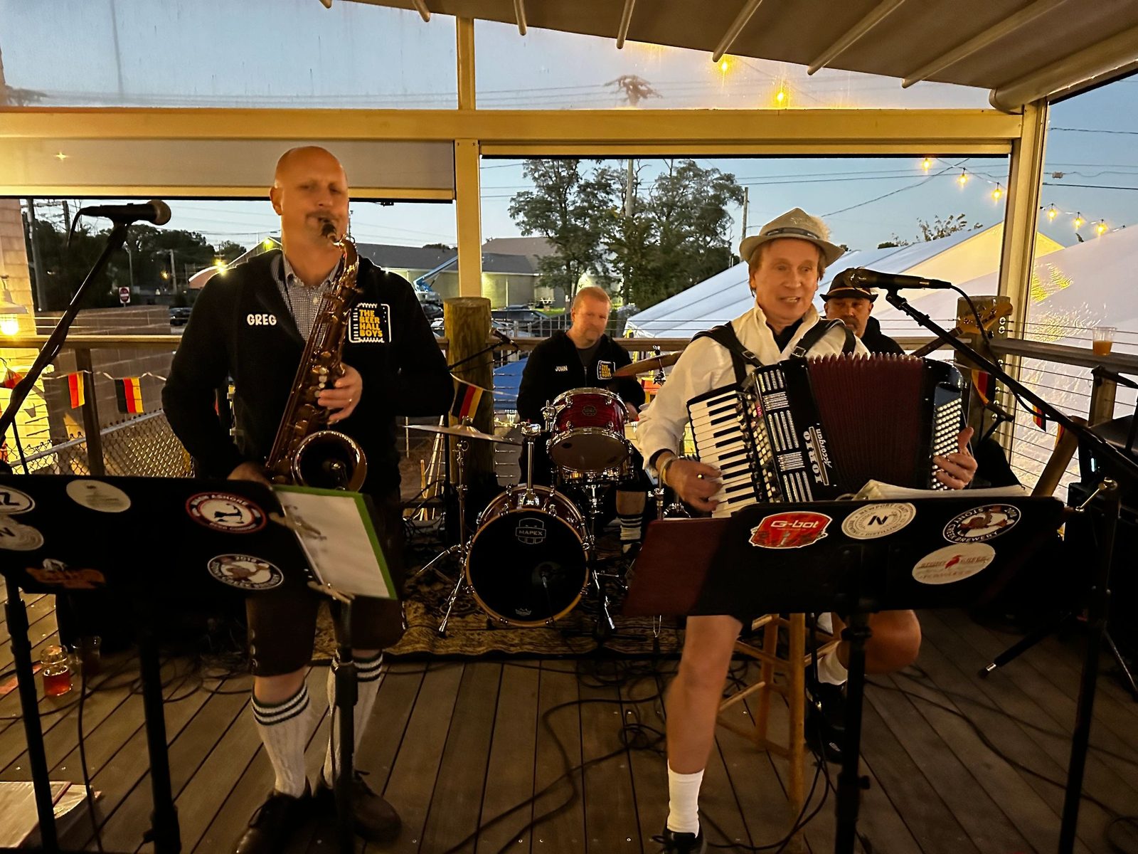 The Beer Hall Boys on an outdoor stage at dusk